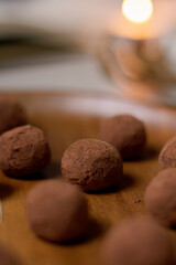 Chocolate truffles covered with cocoa powder. Gray background. Delicious dessert concept.