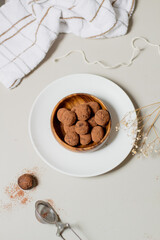 Chocolate truffles covered with cocoa powder. Gray background. Delicious dessert concept.