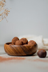 Chocolate truffles covered with cocoa powder. Gray background. Delicious dessert concept.