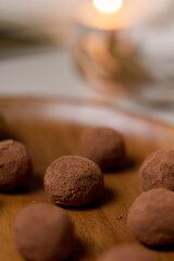 Chocolate truffles covered with cocoa powder. Gray background. Delicious dessert concept.