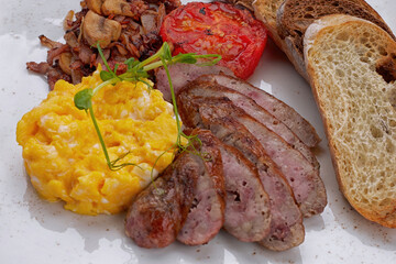 Fried sausages with omelet, mushrooms and toast, Close up