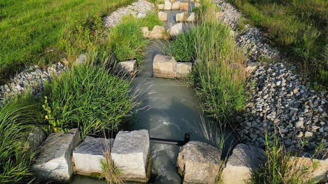 Drone flight following fish ladder downstream at Inn river in Marktl Bavaria in sunset