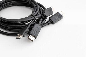 DisplayPort and HDMI Cable for connecting a computer to a monitor and other multimedia consumer electronics, close-up in selective focus on a white background