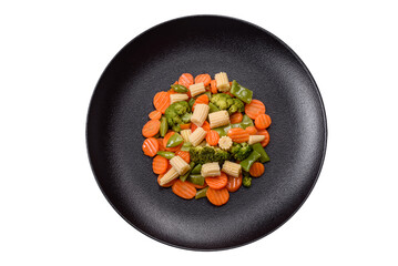 A mixture of vegetables: carrots, small heads of corn, asparagus beans steamed