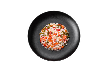 Delicious fresh risotto with vegetables, spices and herbs on a black plate