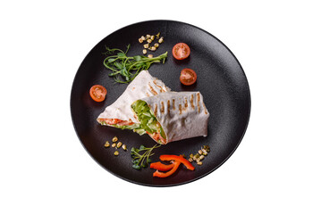 Delicious fresh shawarma with tomatoes, peppers, cucumber on a dark concrete background