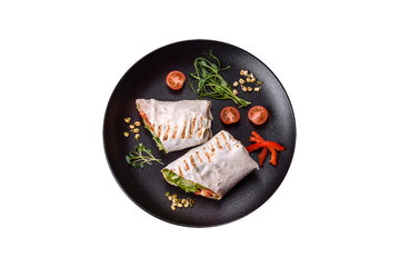 Delicious fresh shawarma with tomatoes, peppers, cucumber on a dark concrete background