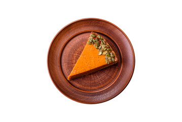 Beautiful tasty pumpkin pie with slices on a black ceramic plate