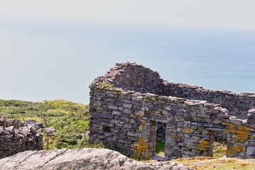 ruined stone house against the sea in Barmouth, UK