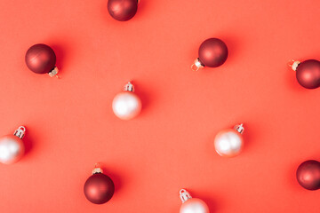 White and dark red Christmas balls on red background, texture