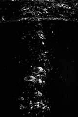 Air bubbles in water on black background