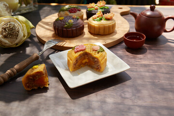 Mid Autumn Moon Cake on the wooden board under sunlight 