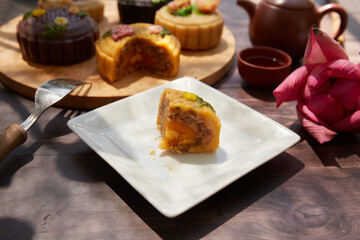 Mid Autumn Moon Cake on the wooden board under sunlight 