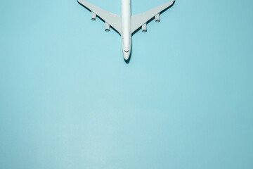 A plane miniature and isolated on blue background, after some edits.