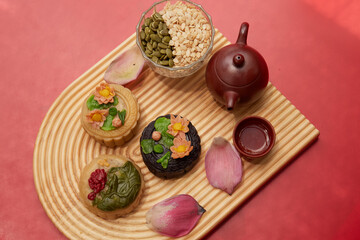 Mid-Autumn Festival food moon cake and tea on red background