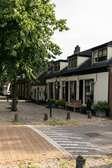 The beautiful street with trees of the historic village of Lage Vuursche in the Dutch forest