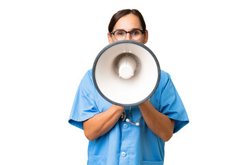 Middle-aged nurse woman over isolated background shouting through a megaphone