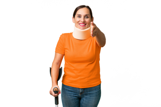 Middle-aged caucasian woman wearing neck brace over isolated background shaking hands for closing a good deal