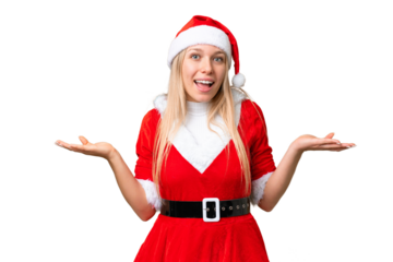 Young blonde woman with christmas hat over isolated chroma key background with shocked facial expression