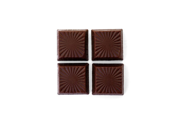 Pile of chocolate square candies with cocoa filling isolated on a white background.