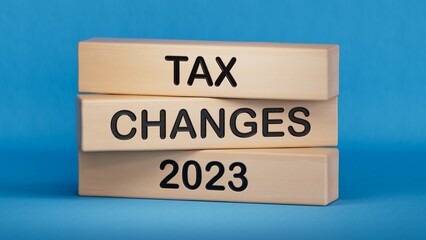 Tax changes 2023 symbol. Concept words Tax changes 2023 on wooden blocks. Business Tax changes 2023 concept. Copy space.3D rendering on blue background.
