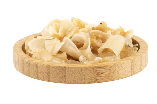 dried gum tragacanth in a wooden bowl