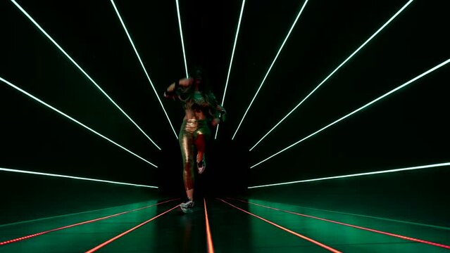 fashion model woman dancing and posing, illuminating herself by led flashlights, sport and fashion