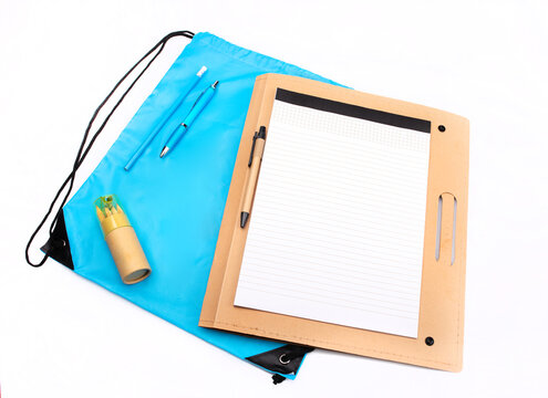 School set - clipboard with blank sheet , pen, colorful crayons and blue sport bag, isolated. 