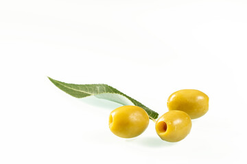 Three green olives on a white background close-up