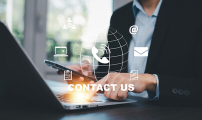 Communication and Contact us or Customer support hotline people connect. Hand using a laptop and touching on virtual screen contact icons, email and address, live chat with internet wifi.