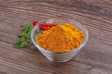 Yellow vibrant curcuma powder in the bowl