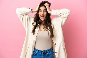 Young caucasian woman isolated on pink background doing nervous gesture