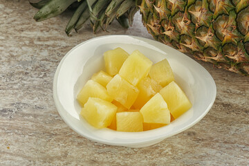 Marinated pineapple slices in the bowl