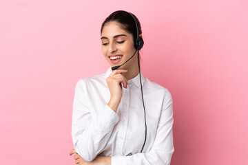 Young telemarketer over isolated background looking to the side and smiling