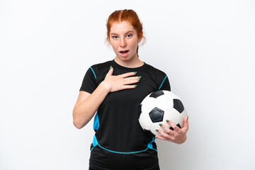 Young caucasian reddish football player woman isolated on white background surprised and shocked while looking right