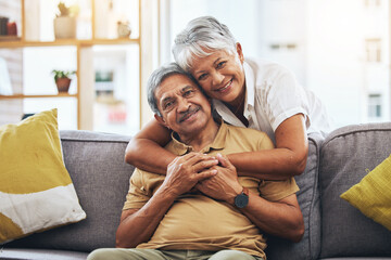 Portrait, hug and senior couple on sofa for bonding, healthy marriage and relationship in living room. Retirement, love and happy man and woman on couch embrace for trust, commitment and care at home - Powered by Adobe