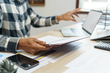 Attractive confident Hispanic Business man using laptop computer and professional working investor start up project business planning in office
