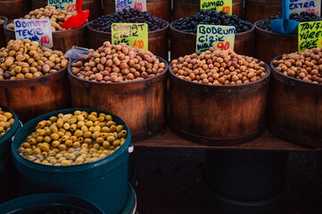 Different olives sale in the traditional farm Turkish market, a counter filled with fresh fruits