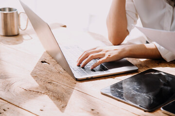 Entrepreneur Asian businessman and businesswoman discussing new business project in tablet in modern Meeting In Modern Office, Asian business casual concept.