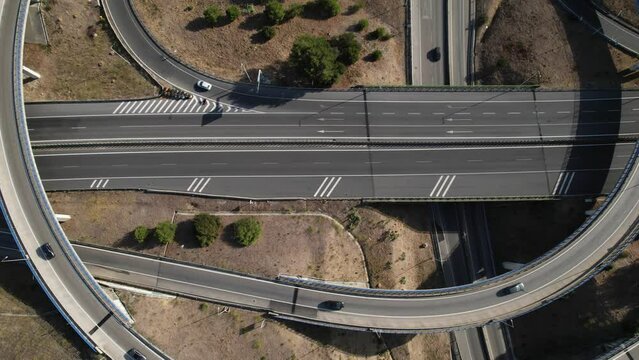 Aerial drone top down sideways panning of elevated highway junctions and interchange overpass ring roads