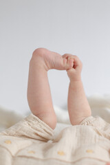 baby holding feet