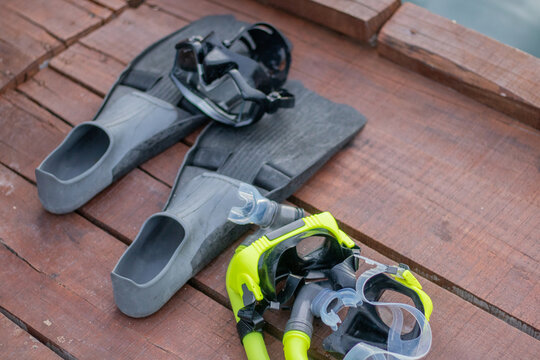 Full set of Scuba Diving equipment with selective focus on wooden pier.