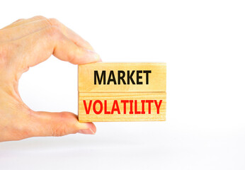 Market volatility symbol. Concept words Market volatility on beautiful wooden blocks. Beautiful white table white background. Businessman hand. Business market volatility concept. Copy space.
