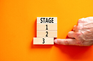 Time to stage 3 symbol. Concept word Stage 1 2 3 on wooden block. Businessman hand. Beautiful...