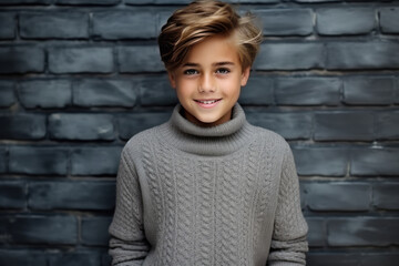 Happiness European Boy In Gray Sweater On Brick Wall Background. Сoncept Happy European Boy In Gray Sweater, Brick Wall Backgrounds, Clothes And Expression Reflecting Moods, Celebrating Diversity