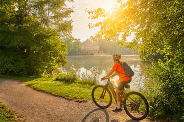 nice woman with electric mountain bike, cycling in moody morning light on the Neckar valley bicycle...