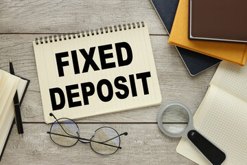 Fixed Deposit. centered with text near magnifier and notepad