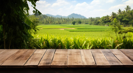 Obraz premium Empty rustic old wooden boards table copy space with rice field in background. Product display template. Generative AI