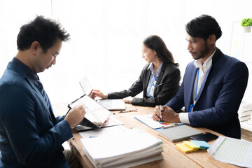 Young colleagues having great business conversations in a modern coworking office. Teamwork concept. Horizontal blurry background. Fireworks.