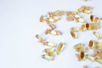 Fish oil capsules and probiotics on a white background
